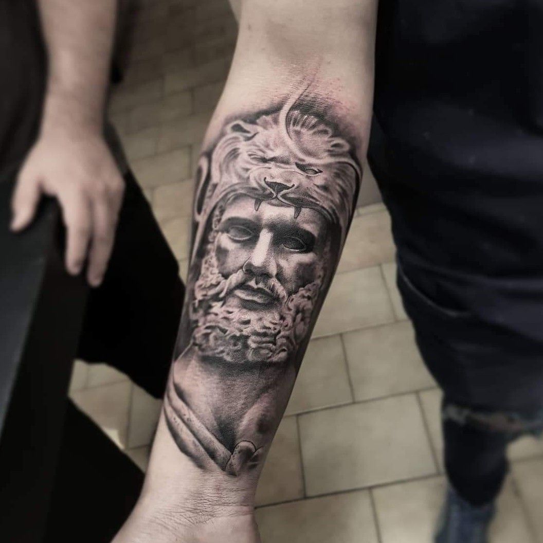 Black and grey Hercules portrait tattoo on the inner