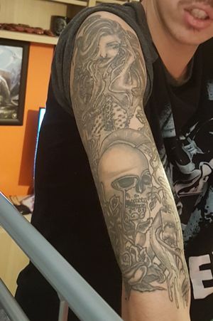 Ancient greek half sleeve medusa with rose bush and some dead soldiers