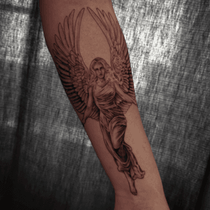Captivating black and gray illustrative tattoo of an angelic woman on the forearm by artist Jones.