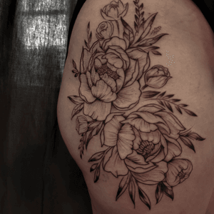 Adorn your upper leg with a striking blackwork peony tattoo by the talented artist Jones. Embrace the beauty and symbolism of this intricate design.