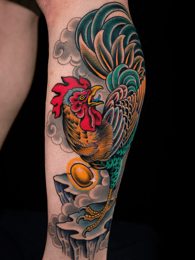 Rooster with gold egg on leg.