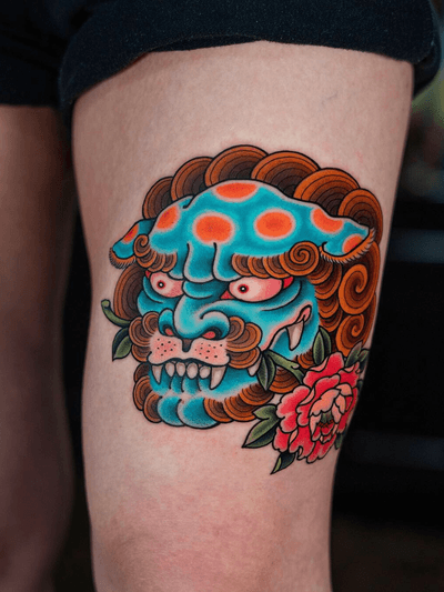 Foo dog and peony on thigh.