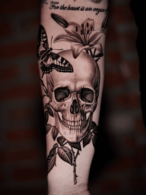 Skull with flower on arm.