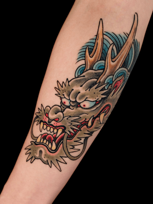 Dragon head on arm.