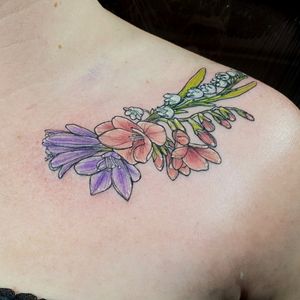 Delicate blossoms along collar bone. Is a very elegant piece, perfect for those starting to get tattooed.