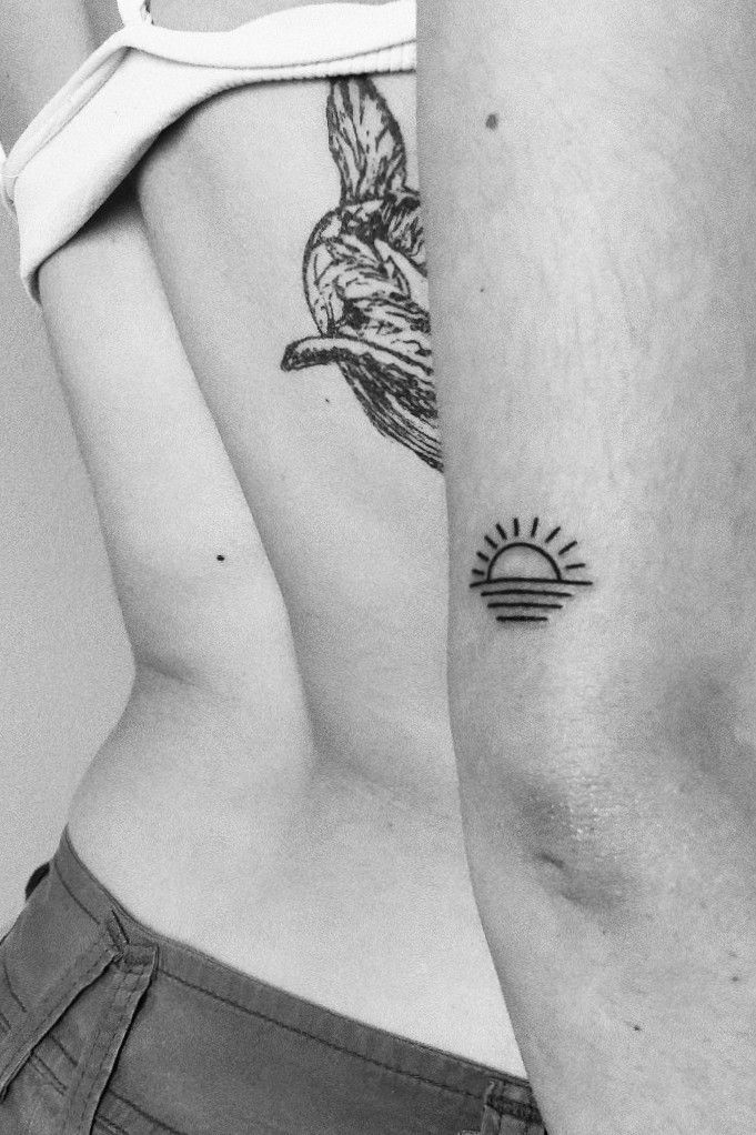 Sunset tattoo on the inner forearm