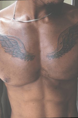 Chest wings tattoo