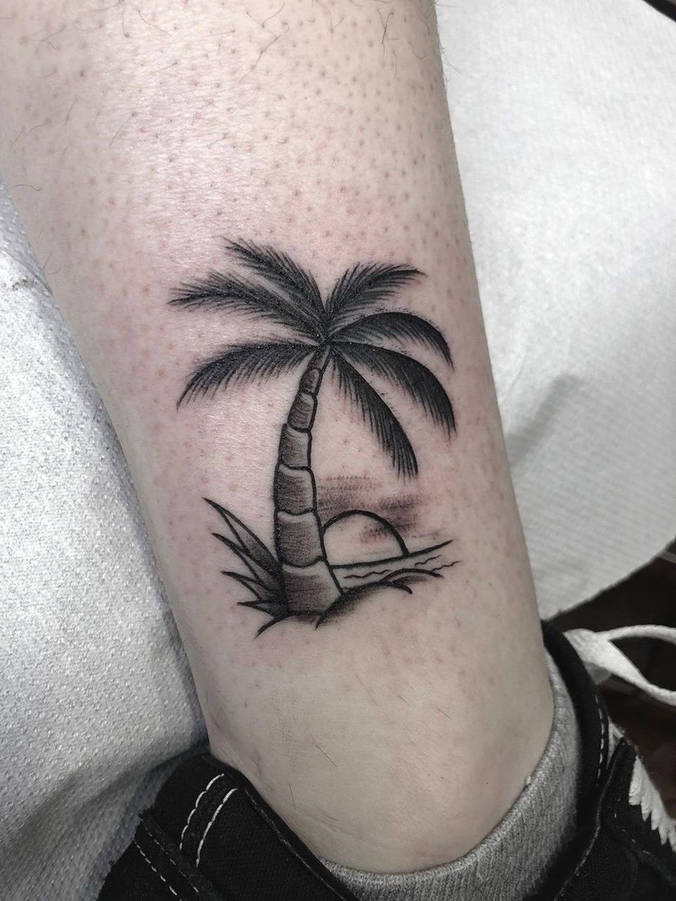 Palm tree tattoo on the ankle