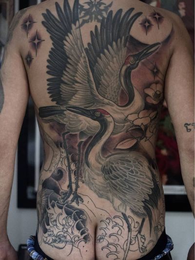 Crane tattoo by Akuma Shugi #AkumaShugi #cranetattoos #crane #birds #feathers #wings #flying #animal #nature #Japanese #neojapanese #neotraditional #backpiece #flowers #waves