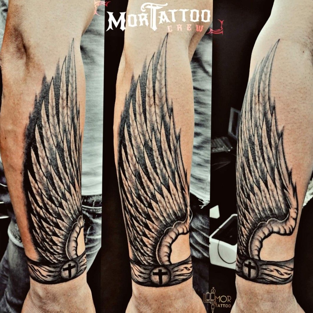 Tattoo uploaded by Mortattoo • #wingstattoo #wing #arm #cross  #bracelettattoo #bracelet #feathers #blackandgreytattoo • Tattoodo