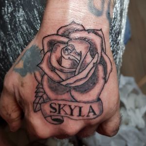 Rose and scroll hand tattoo