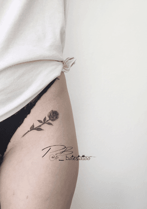 Beautiful blackwork thigh tattoo featuring an illustrative flower design by renowned artist Patrick Bates.