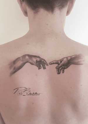 Experience the stunning blackwork realism of Patrick Bates with this captivating hand tattoo on your upper back.