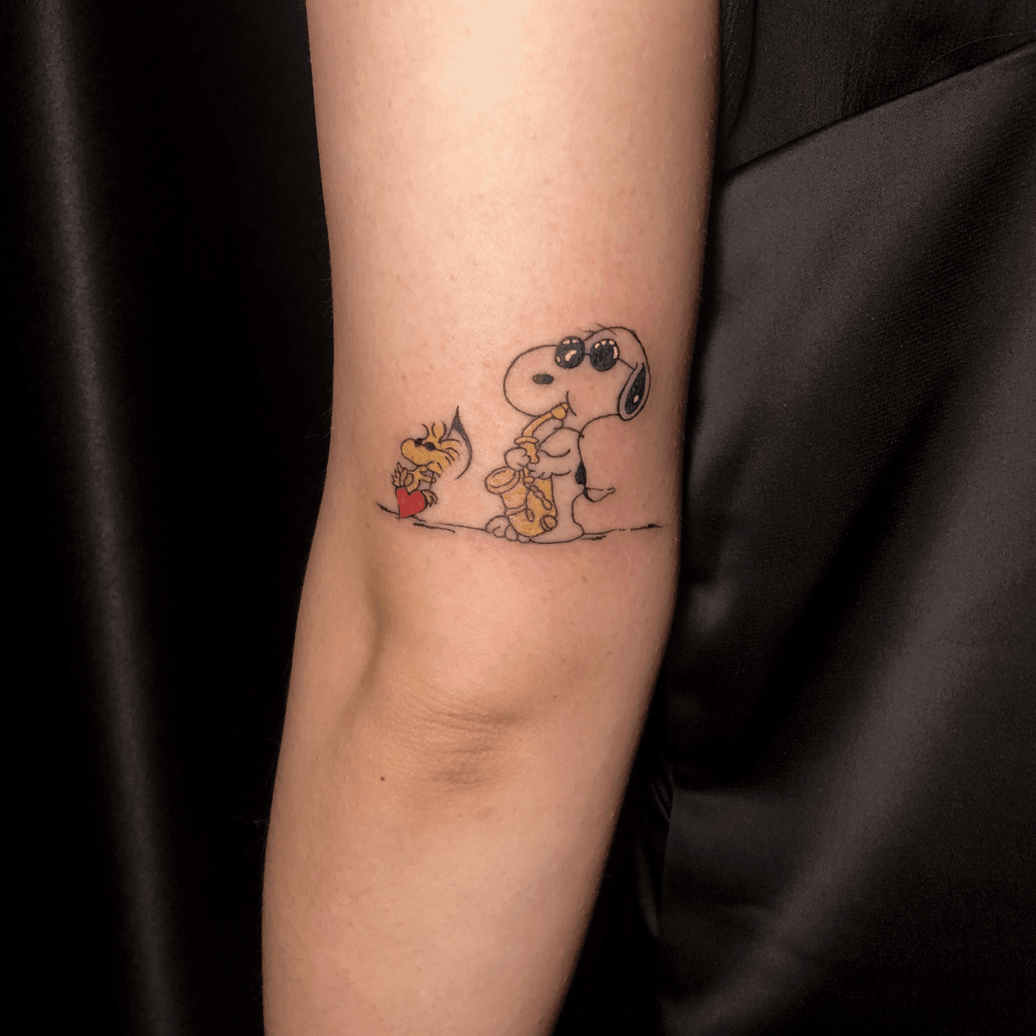 Snoopy and Woodstock tattoo located on the hip