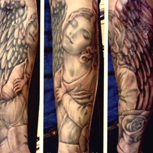 Soft Black and Grey angel and Sleeve forearm Tattoo by tattoo artist Heather Gellately, Owner and Artist of Platinum Tattoo: Kelowna Bc Canada. Visit Https://www.TattooPlatinum.com/pinups-and-portraits to view more of her Amazing tattoos. The Platinum Tattoo website features Convenient Online Booking for tattoo artist Heather Gellately. Book your appointment today! All tattoo deposits are secured safely through PayPal .