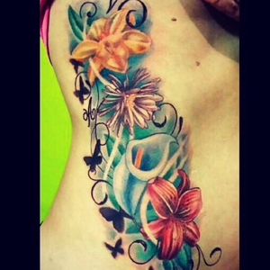 #Vibrant #realistic #birthflower #sidetattoo  by tattoo artist Heather Gellately, Owner and Artist of Platinum Tattoo: Kelowna Bc Canada. Visit Https://www.TattooPlatinum.com/flowers to view more of her Amazing tattoos. The Platinum Tattoo website features Convenient Online Booking for tattoo artist Heather Gellately. Book your appointment today! All tattoo deposits are secured safely through PayPal .