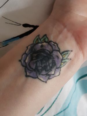 Small flower on my wrist to cover up a previous tattoo...