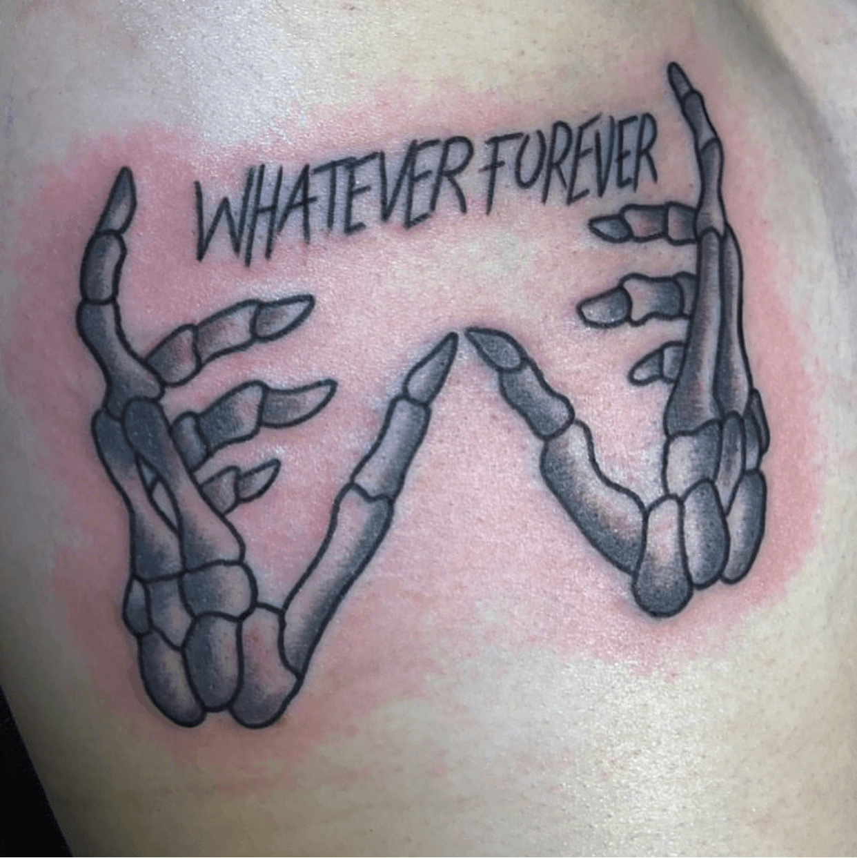 Tattoo of the word whatever handwritten on the upper