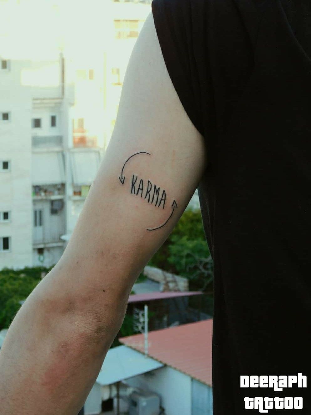 Karma lettering tattoo on the hand