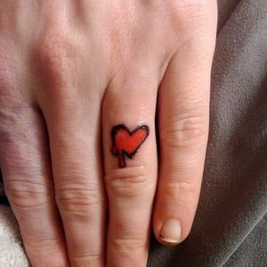 Bleeding heart. Hand poke. Trash polka style. Finger tattoo.