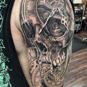 Black and Grey Realism Skull and Clock tattoo performed by Gentle Josh at The Crow's Nest in Dubuque Iowa 