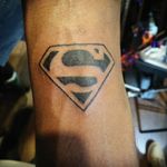 Superman arm tattoo