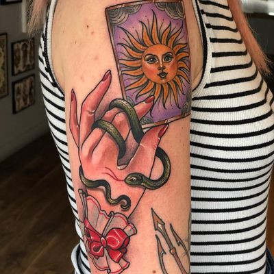 Tattoo of a hand by Sadee Glover #SadeeGlover #upperarm #arm #bicep #tattoosofhands #tattoohand #handtattoo #hands #fingers #bow #tarot #tarotcard #sun #bow #snake #serpent #reptile #neotraditional #color
