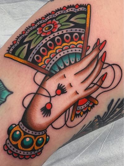 Tattoo of a hand by Matt Cannon #MattCannon #upperleg #tattoosofhands #tattoohand #handtattoo #hands #fingers #color #traditional #fan #decorative #pattern #flower