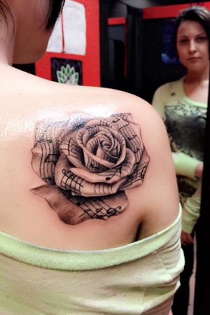 Music note paper folded into a rose. I got this for my grand mother who passed and my mother.  One of my favorite tattoos on my body. 