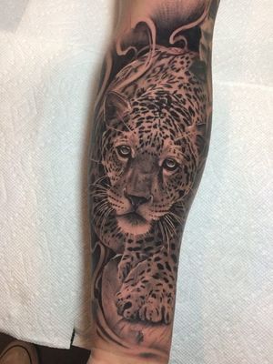Leopard tattoo by Mike Flores #MikeFlores #leopard #junglecat #cat #forearm - Top 10 Cities to Get Tattooed In #Austin #tattooidea #tattoo #tattooart #vacation #travel #top10 #top10cities #gettattooed