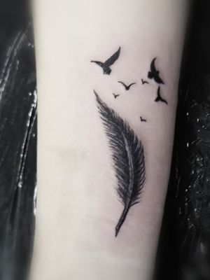 Feather and bird wrist tattoo