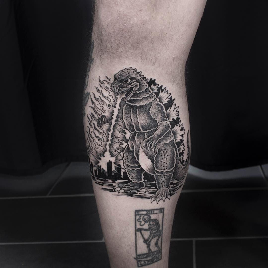 Tattoo uploaded by Tattoodo • Godzilla tattoo by Mike End #MikeEnd  #lowerleg #godzilla - Top 10 Cities to Get Tattooed In #Paris #tattooidea # tattoo #tattooart #vacation #travel #top10 #top10cities #gettattooed •  Tattoodo
