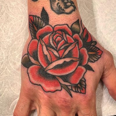 Rose tattoo by Paul Dobleman #PaulDobleman #rosetattoo #handtattoo - Top 10 Cities to Get Tattooed In #SanFrancisco #tattooidea #tattoo #tattooart #vacation #travel #top10 #top10cities #gettattooed