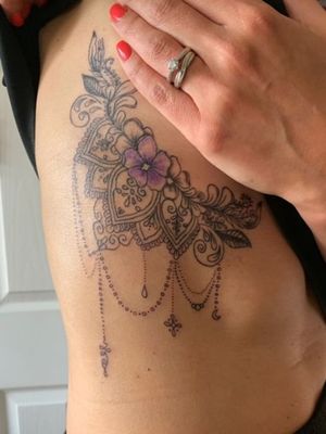 Side boob mandala design, including her son's birth flower. #tattoooftheday 