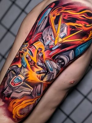 Colorful tattoo by Hori Benny #HoriBenny #halfsleeve #upperarm #arm #gundamwing #anime #manga #fire #newschool #colorfultattoo #colorful #color #vibrant