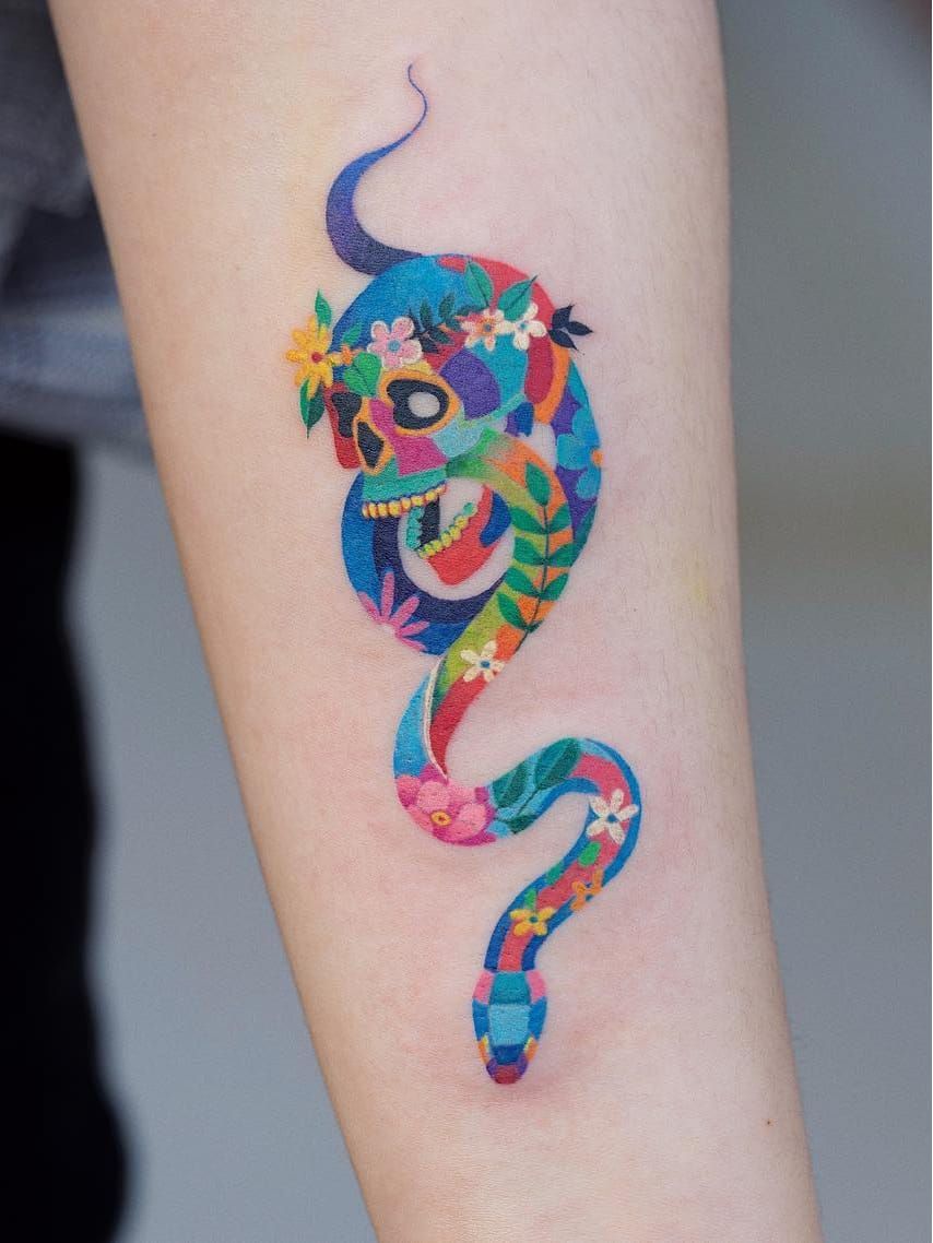 Snake tattoo coloured in a Gustav Klimt blue pattern