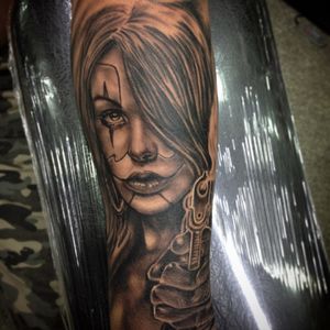 Chicano girl with gun tattoo outter arm at Alanya studio