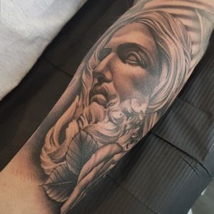 Get a stunning black and gray tattoo of Jesus done by the talented artist Dani Mawby. Embrace your faith with this beautiful and lifelike design.