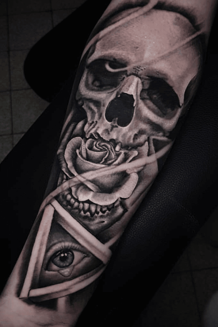 Surrealist skulleye forearm tattoo