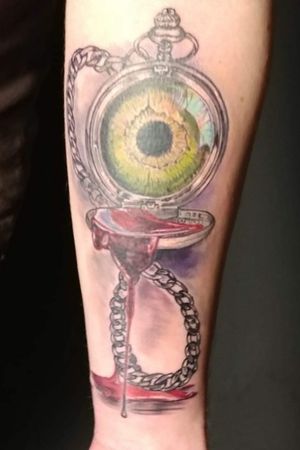 Green eye in a pocketwatch with the chain in the shape of Infinity and blood dripping from the open cover.This came to me several years ago as a random thought and I got it done earlier this year.