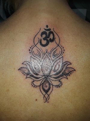 Chakra symbol Third eye chakra with lotus flower.  Still needs the purple added and doing that asap! The placement is approx on the 3rd vertebrae  of my spine. Placement is very important.  Shannon Bryant is an amazing artist and I've had several tattoos done by him. He comes highly recommended.  