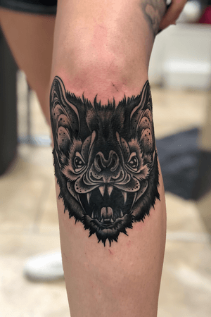 Bat under knee tattoo