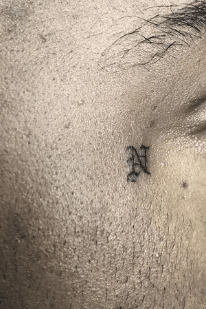 N face tattoo