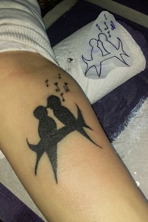 lovebirds silhouette with lettered musical notes. a engagement piece #birdtattoo #silhoutte #lovebirds #ink #forearmtattoo 