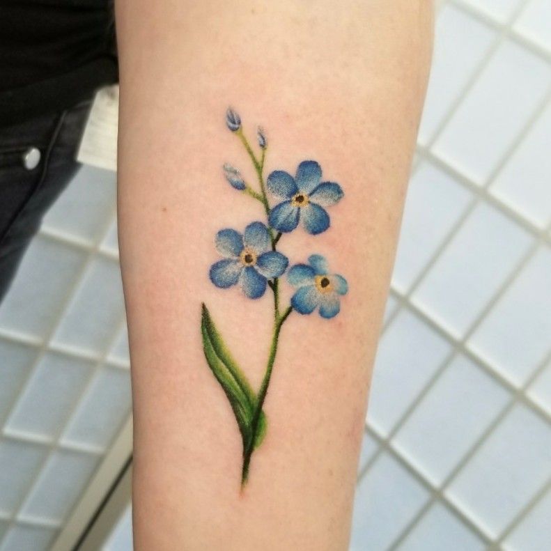 Forgetmenot flower tattoo on the left side of the