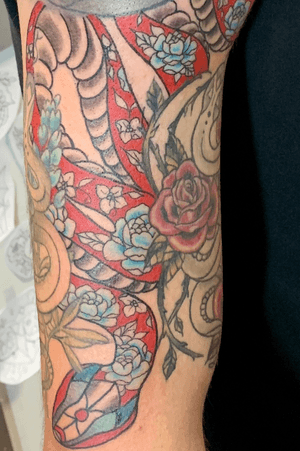 Added a snake made of flowers to fill in the open space on my arm. I decided to make the background a solid light red. 