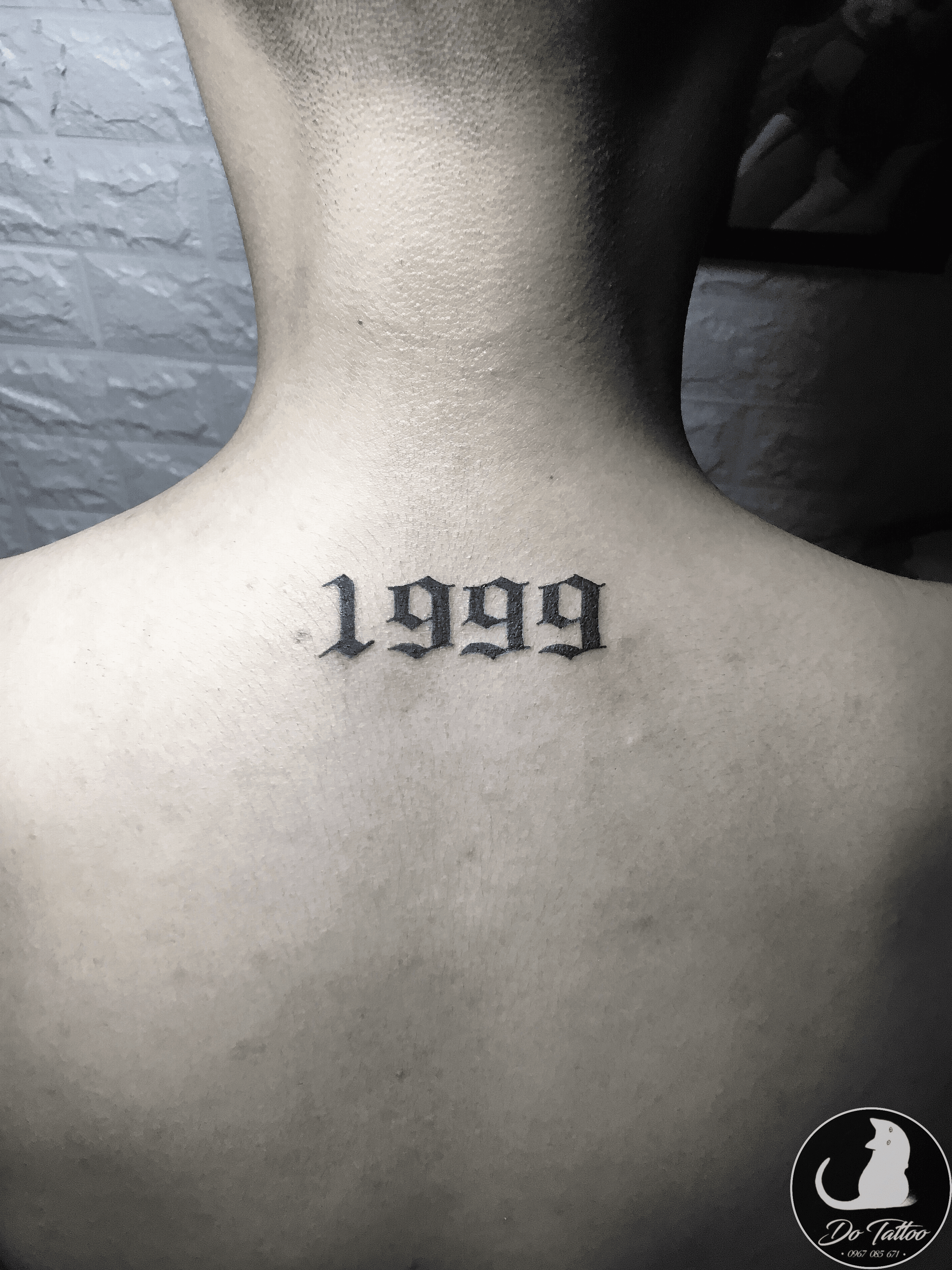 1998 lettering tattoo on the neck