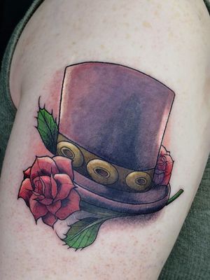 Adorn your upper arm with a stylish neo-traditional hat tattoo designed by the talented artist Adrian Suez.