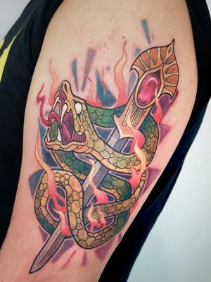 Adrian Suez's stunning upper arm piece features a bold neo traditional design of a snake wrapped around a dagger.