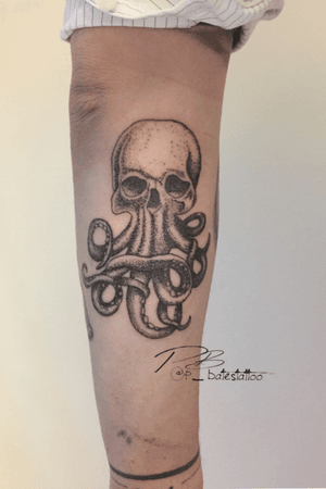 Unique blackwork illustrative tattoo by Patrick Bates featuring an octopus intertwined with a skull design on the forearm.